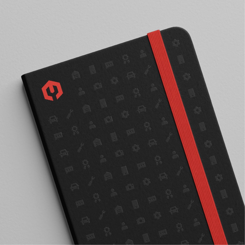 A black notebook with embossed icons and a red Shop Boss logo.