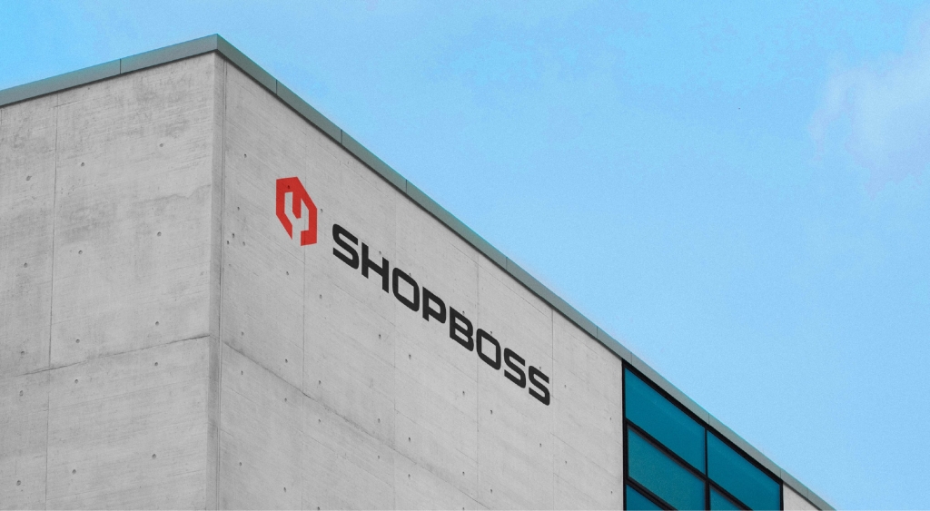 A concrete building displaying the Shop Boss logo.